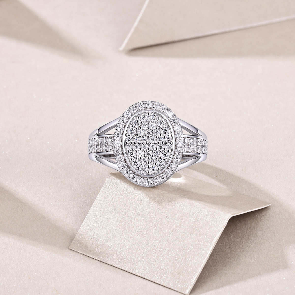 CARISSIE round moissanite halo ring, top-down view resting on a card showcasing the full diamond coverage