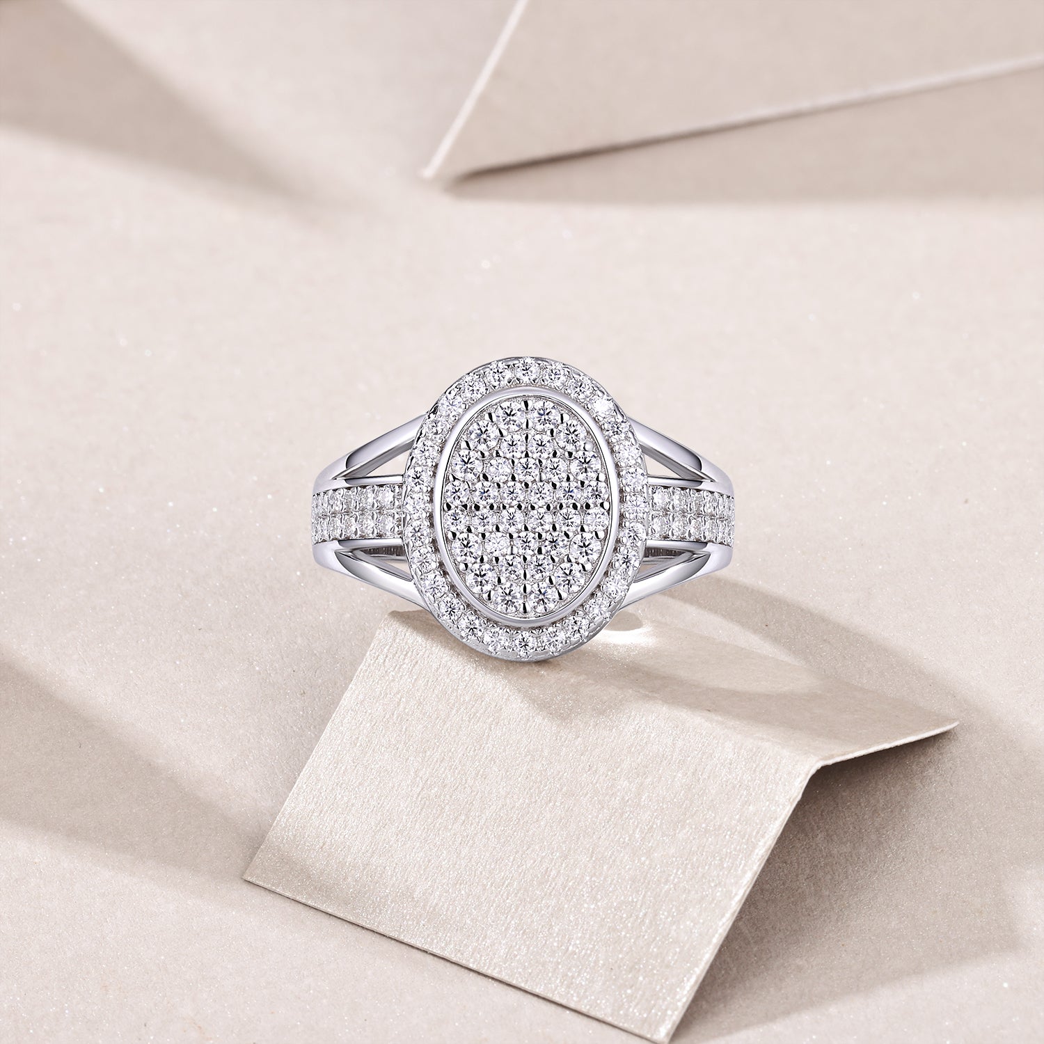 CARISSIE round moissanite halo ring, top-down view resting on a card showcasing the full diamond coverage