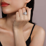 CARISSIE round moissanite halo ring, on model shot showing scale and sparkle against skin near the face