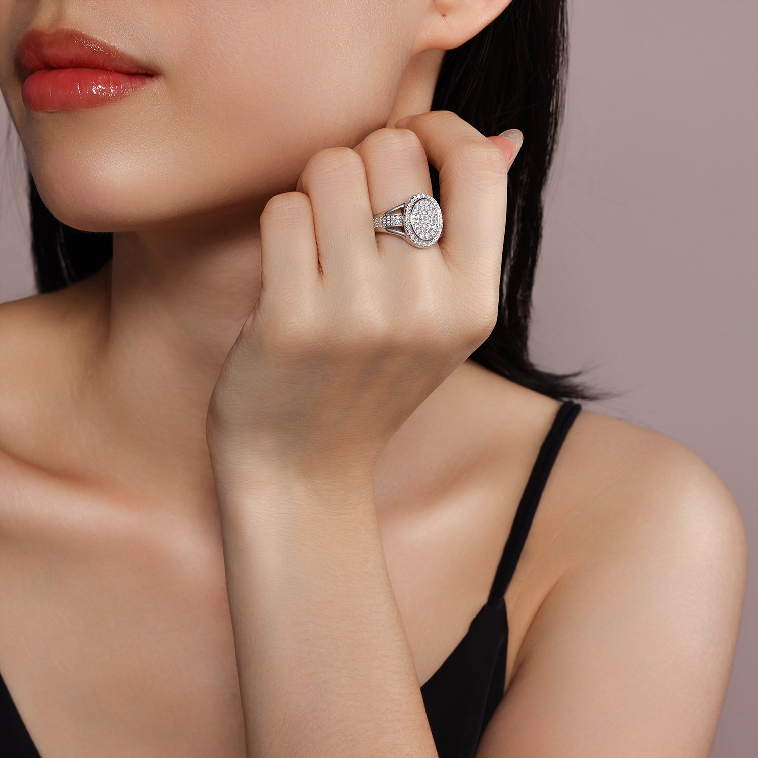 CARISSIE round moissanite halo ring, on model shot showing scale and sparkle against skin near the face