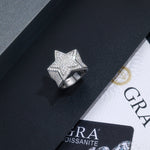 CARISSIE round moissanite pavé ring, top-down view of star motif on black box with GRA certificate