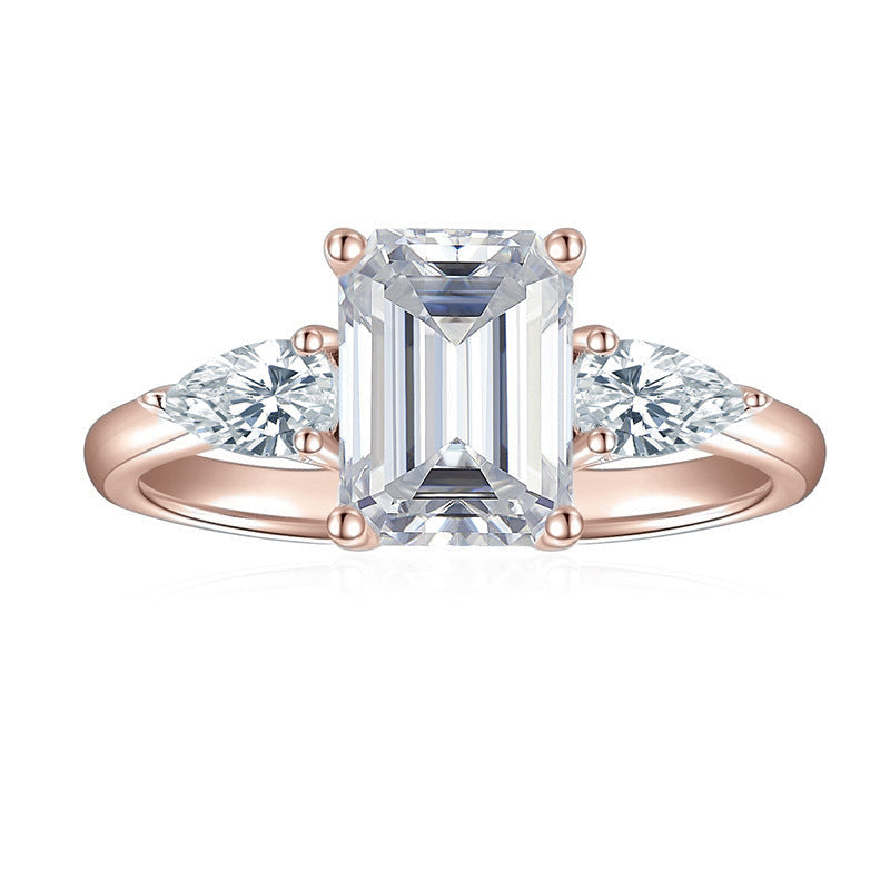 Eleanor Emerald Cut Moissanite Three Stone Engagement Ring in 18K rose gold plating, front view