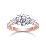 Kenzie Round Moissanite Three Stone Engagement Ring in 18K rose gold plating, front view